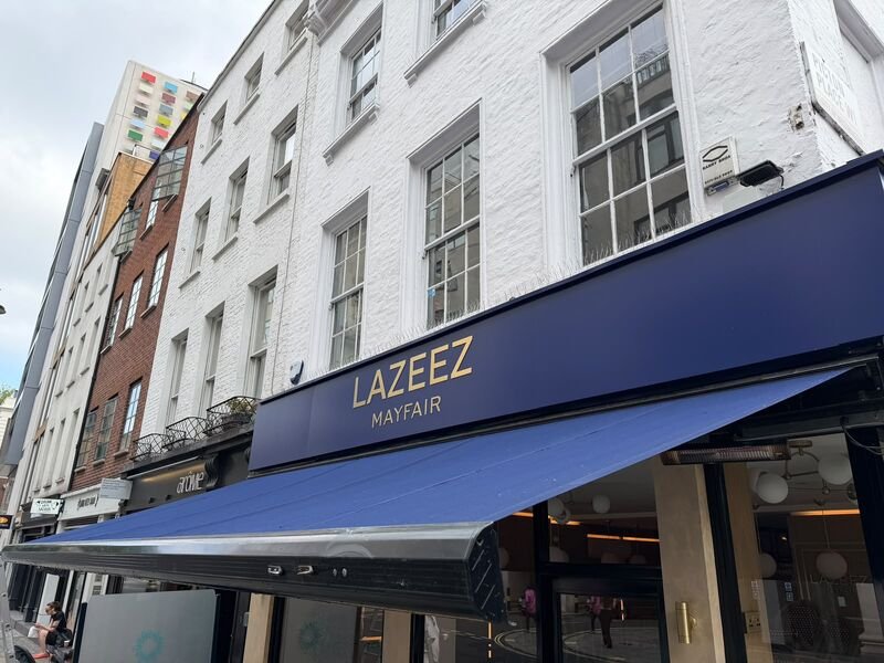 The navy awnings and signage above the finished Lazeez Mayfair shopfront